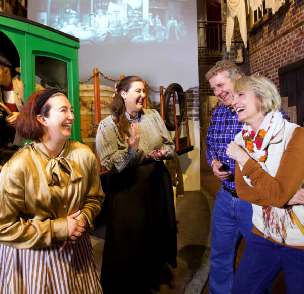 Visitors and tour guides on a guided museum tour inside the American Prohibition Museum