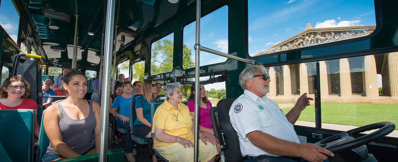 interior of Nashville Old Town Trolley vehicle with guests looking out the window at Nashville Parthenon