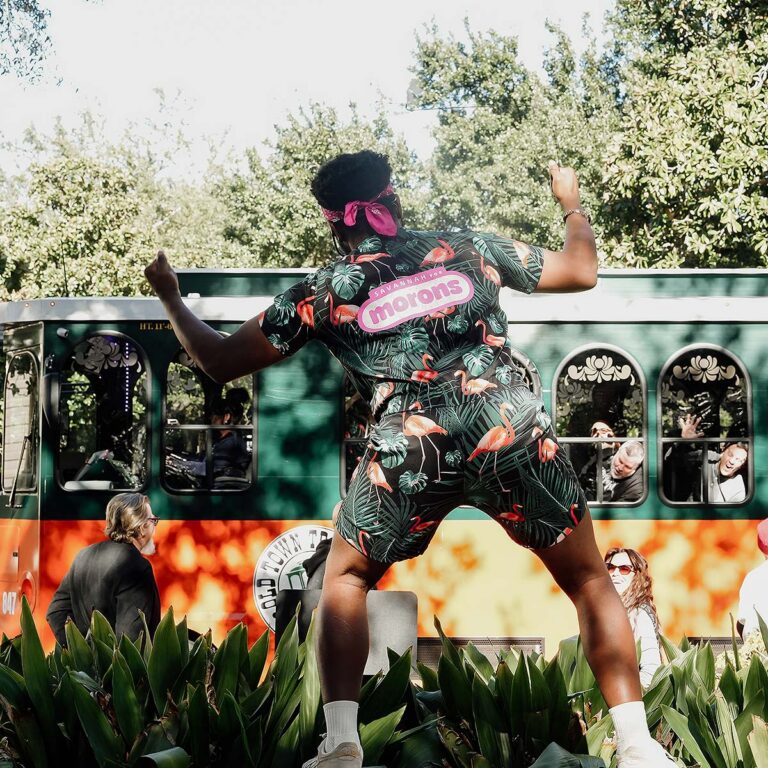 Savannah for Morons host in front of trolley and guests