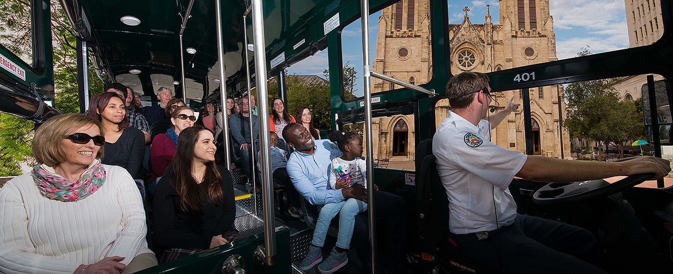interior of San Antonio Old Town Trolley vehicle with guests looking out the window at San Fernando Cathedral