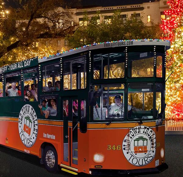 San Antonio holiday trolley surrounded by holiday lights and Christmas tree