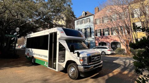 Charleston trolley driving past Rainbow Row