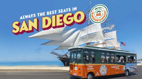 San Diego trolley in front of Star of India ship and the words 'Always the Best Seats in San Diego'