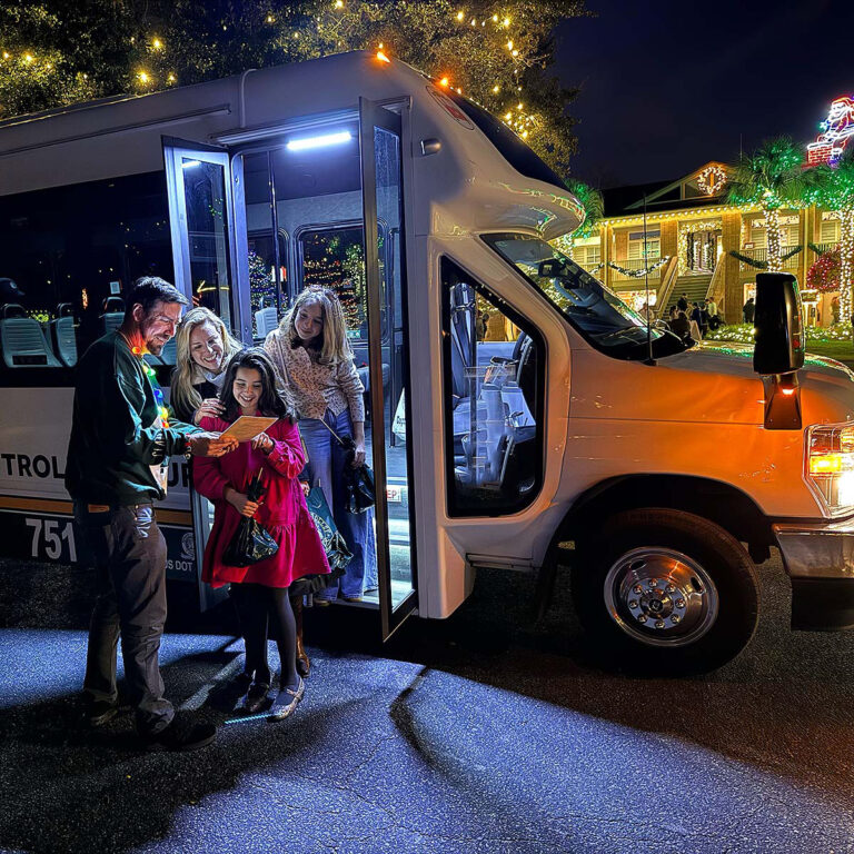 Family and tour guide at Charleston Festival of Lights tour vehicle