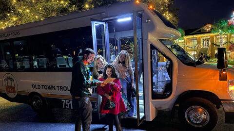 Family and tour guide at Charleston Festival of Lights tour vehicle