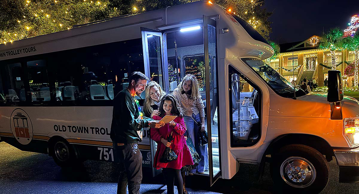 Family and tour guide at Charleston Festival of Lights tour vehicle
