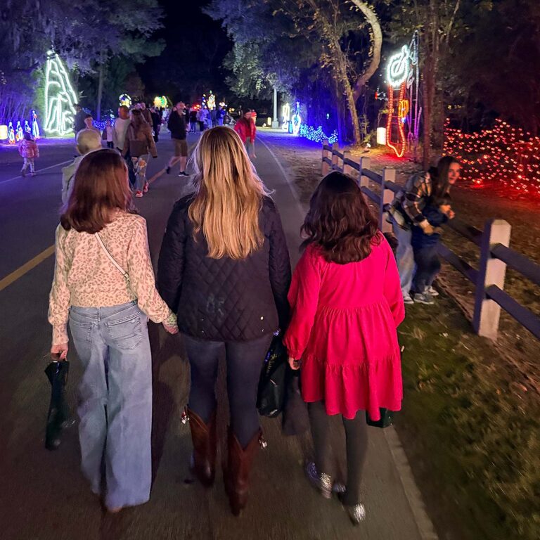 family exploring Charleston holiday lights display