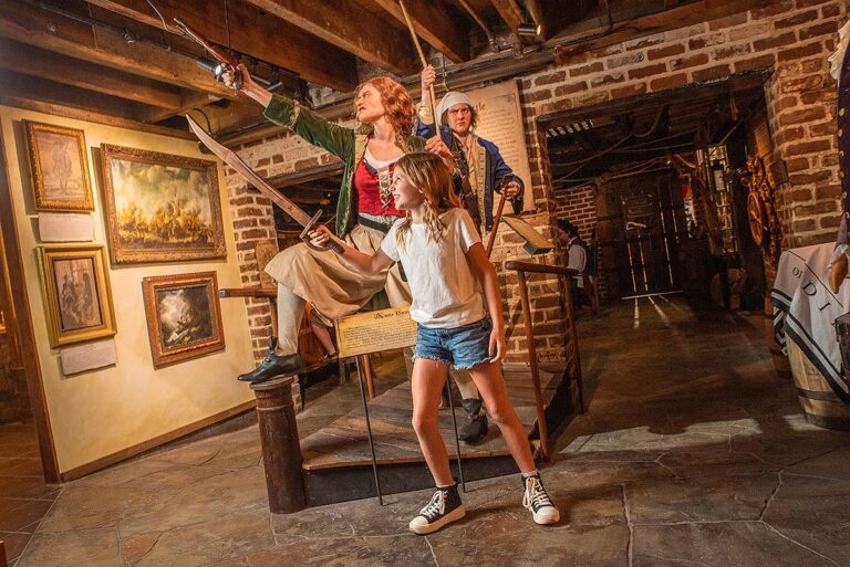 young guest lifting a sword at Savannah Pirates and Treasure Museum