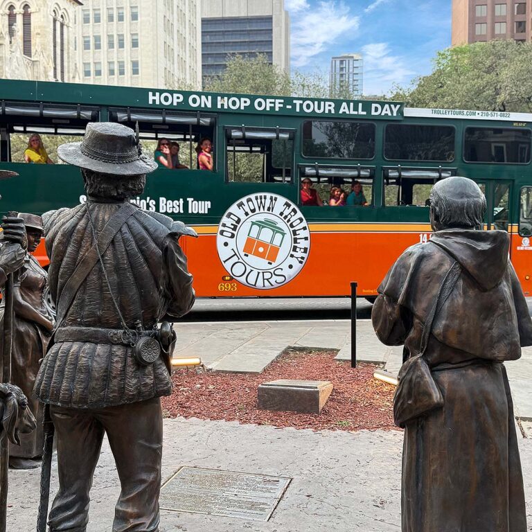 San Antonio trolley driving past Founders Monument