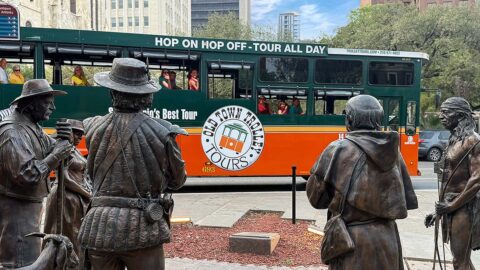 San Antonio trolley driving past Founders Monument