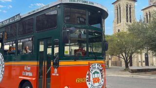Old Town Trolley Tour Tickets - San Antonio trolley driving past San Fernando Cathedral
