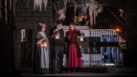 Charleston Ghosts & Gravestones hosts at Bethany Cemetery with tour vehicle in the background