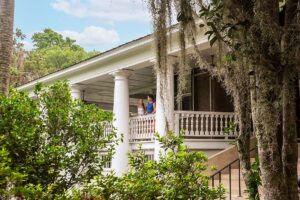 Magnolia Plantation guests standing on house porch