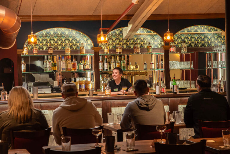 Guests seated at a bar during a whiskey tasting at Old Savannah Distillery